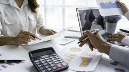 business people meeting in the office Calculate the tax and income of the company's investment. Strategic Planning and Brainstorming colleague concept, report, analyze graph plans